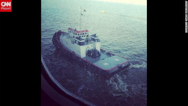 One of two tugboats pulling us through the channel to Mobile, Alabama, along with a channel guide boat, writes Maclaskey. The ship is being towed slowly to Mobile, Alabama, and is expected to port late February 14.