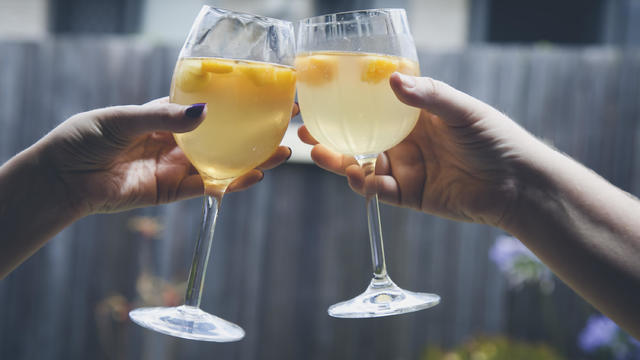 Saying Cheers with two wine glasses 