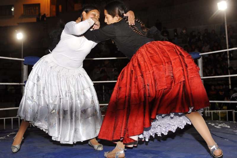 Benita La Intocable (R), faces Simpatica Angela during a cholitas (Aymara women in skirts) all-in wrestling fight on December 4, 2010 in La Paz. The fighting cholitas are one of the main attractions of the catchascan, a kind of circus that perform in popular neighbourhoods of Bolivia.