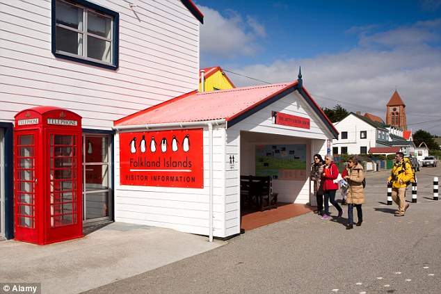 Tourists walk by the Falkland Islands' visitor information centre found near the jetty on arrival