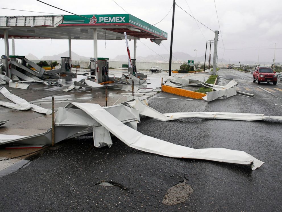 PHOTO: A car drives by a gas station partially destroyed by Hurricane Odile in Los Cabos, Mexico, Sept. 15, 2014.