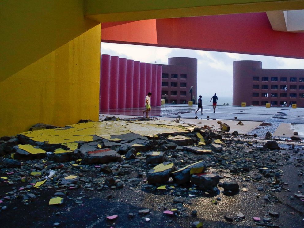 PHOTO: Tourists walks near the entrance of the resort, partially destroyed by Hurricane Odile, in Los Cabos, Mexico, Sept. 15, 2014.