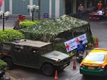 Presentation is everything: Thai soldiers have toned down the intimidating look of army bunkers set up near tourist attractions