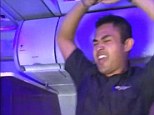 A Virgin America flight attendant performs the pre-flight safety instructions as a dance routine