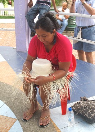 Handcrafted: A woman weaves a Panama hat around a frame in Montecristi, Ecuador