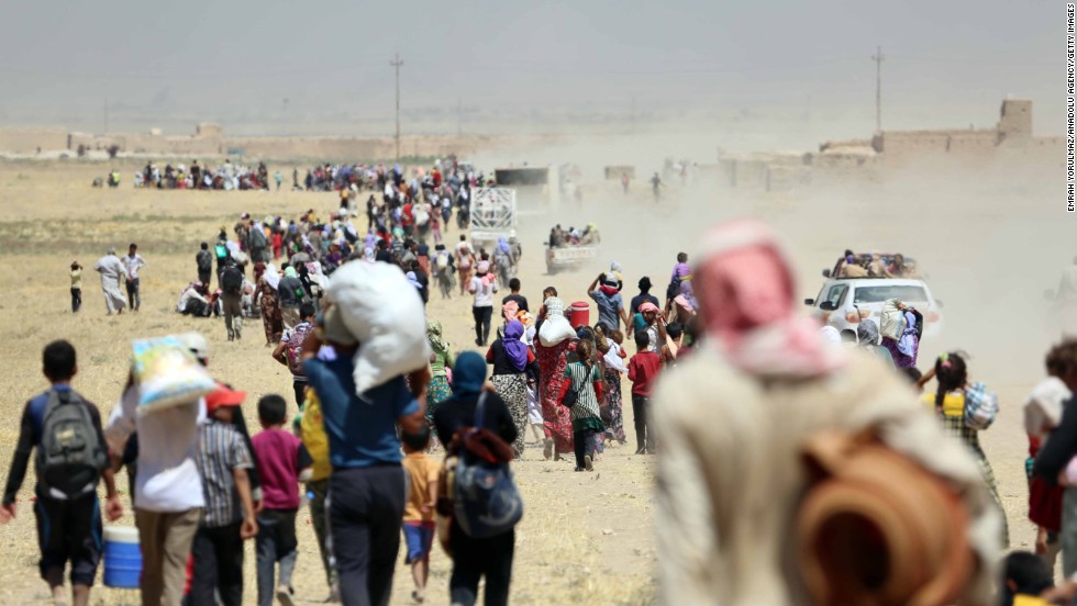 Thousands of Yazidis are escorted to safety by Kurdish Peshmerga forces and a Peoples Protection Unit in Mosul on Saturday, August 9.
