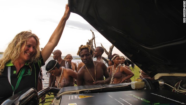 Lizette Kriel, co-owner of electric vehicle company Freedom Won, peeks under the hood of a Land Rover converted from diesel to electric power.