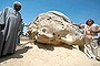 German archaeologist Hourig Sourouzian (C), who heads the project to conserve the Amenhotep III temple, stands next to a newly displayed alabaster head from an Amenhotep III statue in Egypt's temple city of Luxor.