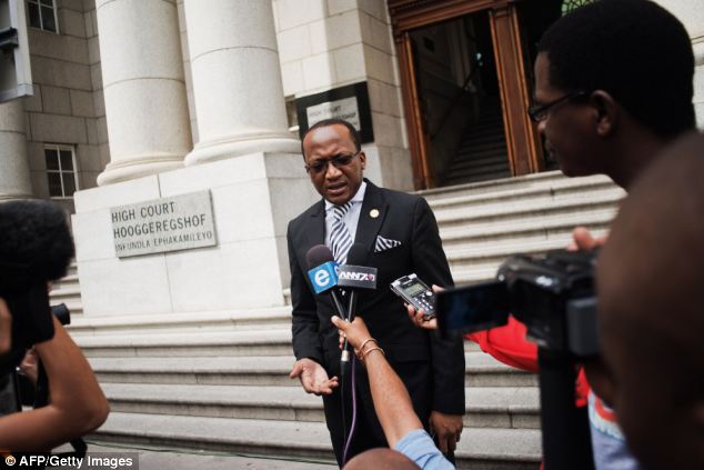South African Department of Justice and Constitutional development spokesperson Mthuzi Mhaga talks to the media in Cape Town outside the Western Cape High Court after briefing the press