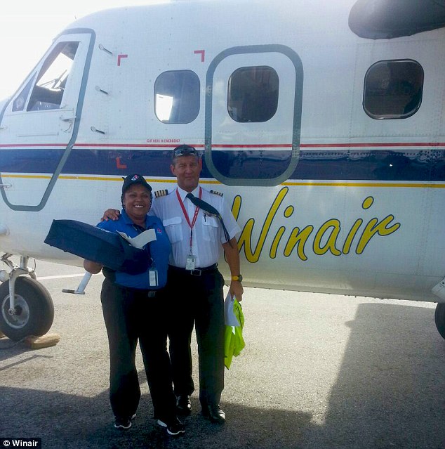 Domino’s employee Shonella Puran and Winair pilot Captain Frederick Rochemont prepare for a delivery