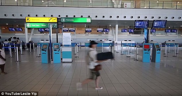 The delivery girl moves quickly  through the airport terminal, anxious to make the plane on time