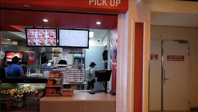 The journey begins here at Domino's Pizza in St Maarten Airport. Pictured is a delivery girl on her way out