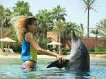 Jade swims with Cassie the dolphin at Dolphin World