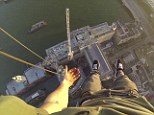 Hanging around: The daredevil freeclimber hangs off the crane on the South Bank Tower in London
