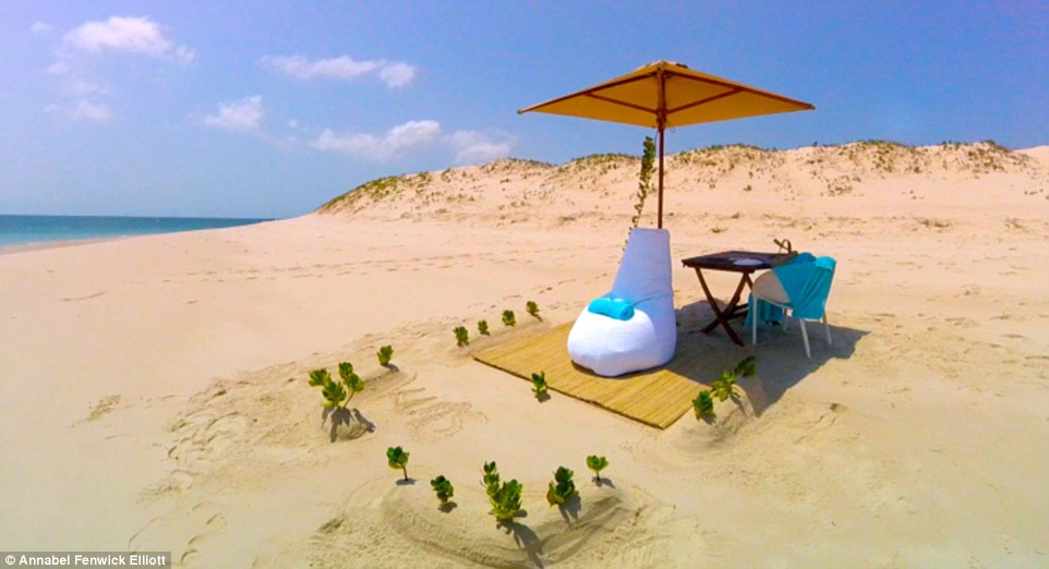 Azura’s legendary private picnic, laid out on a beautifully dressed table under a reed parasol with mounds of sand sculpted around it that were artfully punctured with green foliage