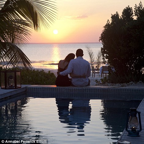 Newlyweds enjoy a blissful sunset from their villa