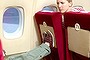 Boy kicking woman's seat on plane