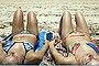 Sunny Queensland during the summer of 2013. I admire the discipline it takes to lie still for so long in such hot weather and as I sat up and looked down at my friend and sister I wanted to take a picture of them so as to remember the holiday and carefree days. But after having just seen an ad about skin cancer I decided to make the picture a little more ?sun-smart friendly?. I drew the sunscreen faces on their bellies, took the shot and smiled when I showed them the photograph. Photo by Monique Horsley