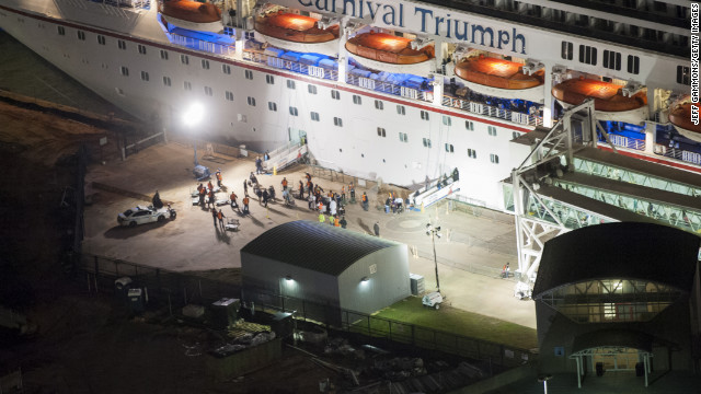 Members of the media wait for the last passengers to disembark the ship. 