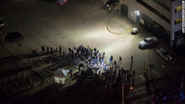 Journalists await the final unloading from the Triumph.