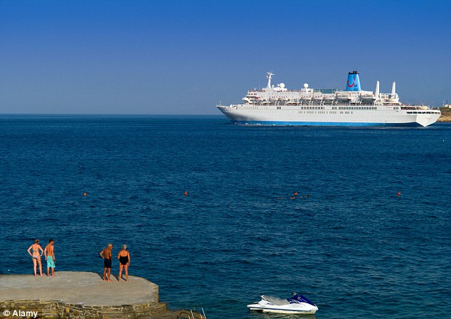Holidaymakers watch the Thomson Spirit cruise ship as it departs the port of Agios Nikolaos in Greece