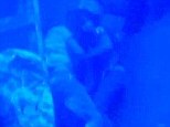 Clinging to each other in the shadow of the sunken hull, this young couple are united even in death. Harrowing underwater footage of the migrant ship that sunk killing more than 300 last autumn has emerged, following another tragic shipwreck off the coast of Lampedusa