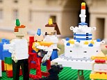 Ah isn't he sweet! The Royal one-year-old flanked by his parents si recreated sitting in his highchair ready for a Lego cake