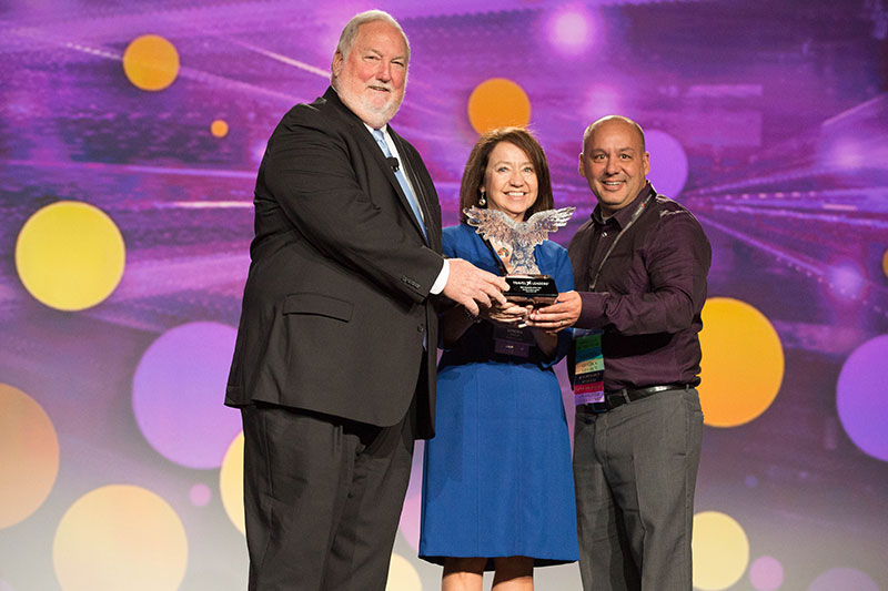 Sandy Lovick and David Lovick Jr. with Roger E. Block, president of Travel Leaders Network