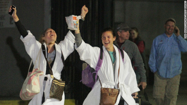 Passengers cheer after stepping off the crippled cruise ship. The last ones got off early Friday, February 15.