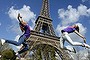 Two Bulgarian tourists pose in front of the Eiffel Tower in Paris on their last day in the capital.