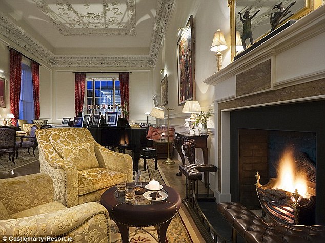 Lavish setting: The Presidential Suite also boasts a separate sitting room with grand design and a piano