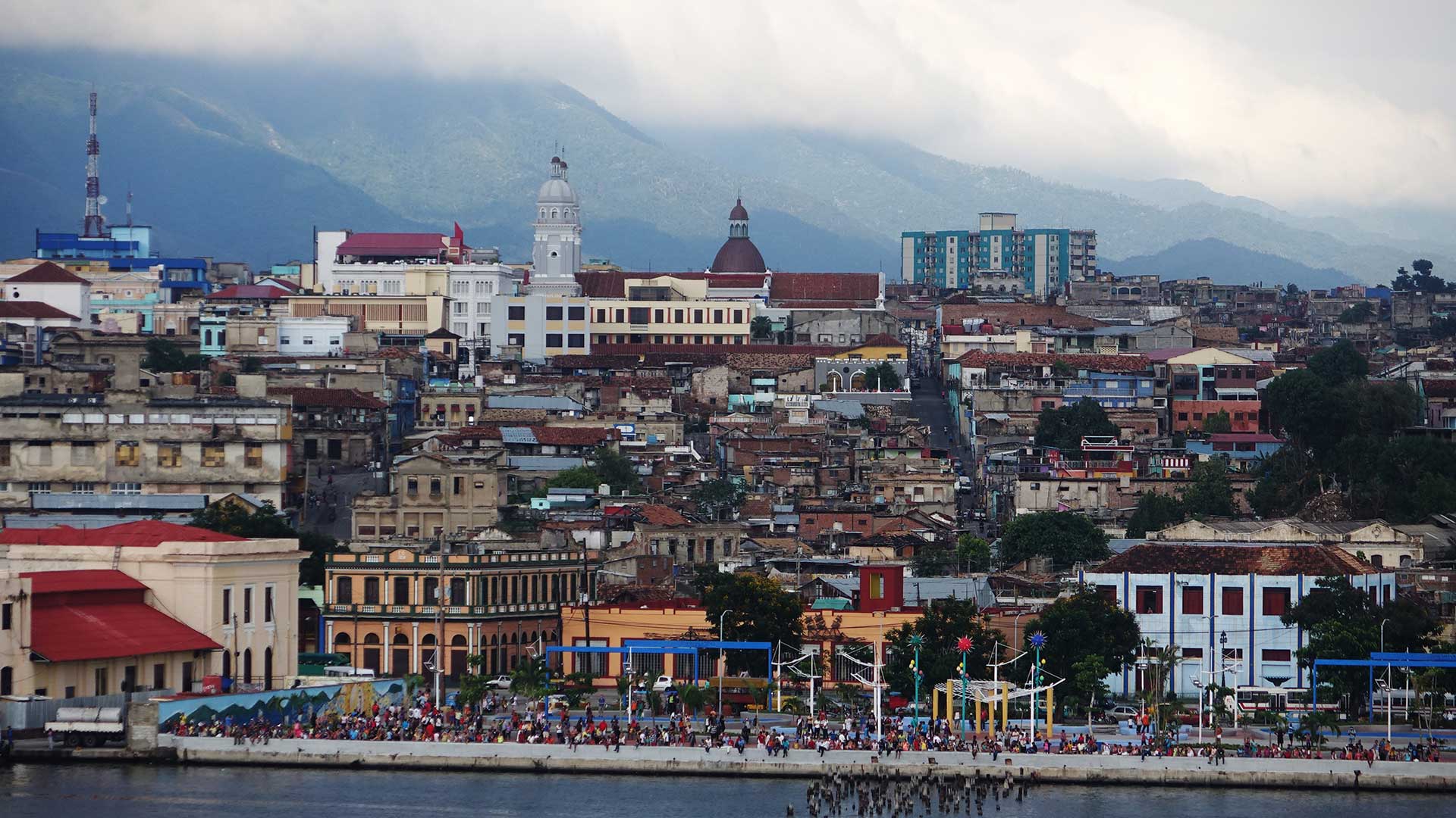 Cubans gather on the malecon to watch as the Fathom Adonia leaves Santiago de Cuba