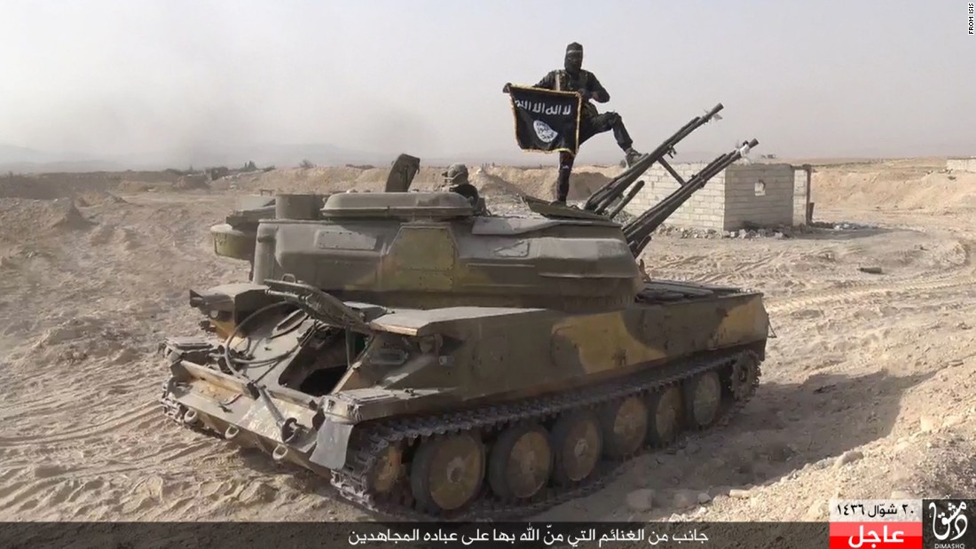 In this image taken from social media, an ISIS fighter holds the groups flag as he stands on a purportedly captured tank after the militant group lt;a href=quot;http://www.cnn.com/2015/08/07/world/syria-isis-al-qaryatayn-christians/index.htmlquot; target=quot;_blankquot;gt;overran the Syrian town of al-Qaryataynlt;/agt; on Thursday, August 6, the London-based Syrian Observatory for Human Rights reported.