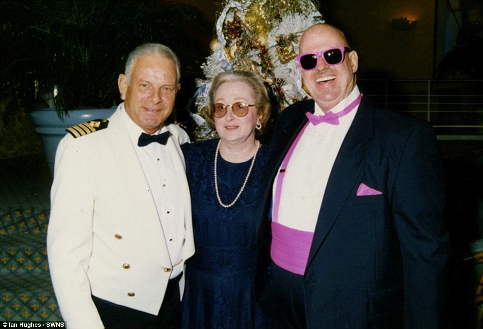 This man, clad in a back and pink tuxedo proves that there's no accounting for taste, while posing with the liner's captain