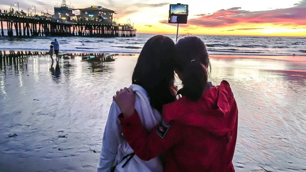 PHOTO: Two tourists take a photo with a selfie stick on the beach in Santa Monica, Calif., Jan. 22, 2015. sunset.