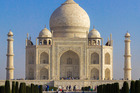 While many can instantly recognise the Taj Mahal in Agra, if you turn around you can see tourists milling around white benches attempting to take the iconic snap. Photos / iStock, Oliver Curtis
