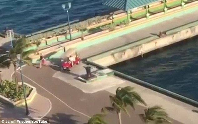 The father leaps from a buggy after picking up his wife and attempts to flag down the departing ship