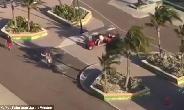 After leaping from the buggy, the mother runs to the edge of the dock, as her husband (left) approaches her 