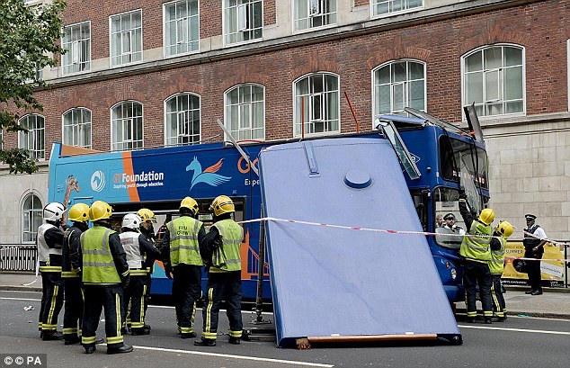 The roof was swept almost clean off the 11.8-tonne bus ¿ which was carrying about 50 tourists at the time ¿ and was later pictured hanging off to one side