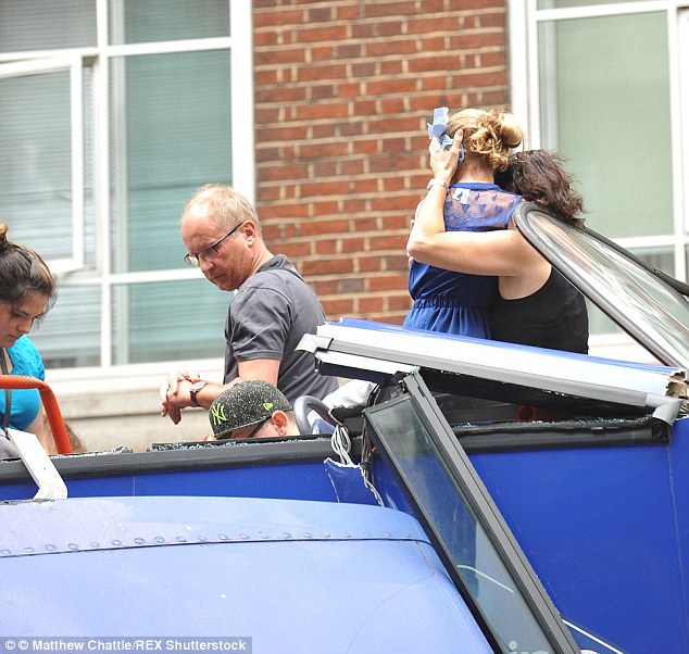 A woman can be seen embracing a child in the aftermath of the crash, surrounded by shattered glass, and Luszczewski's son can be seen bending down to his father