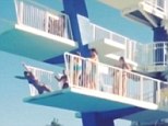 After losing her grip of the railings above she then falls on to the platform below stomach first, which flips her into the air
