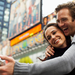 Couple Taking Self Portrait in New York City © Radius Images/Getty Images