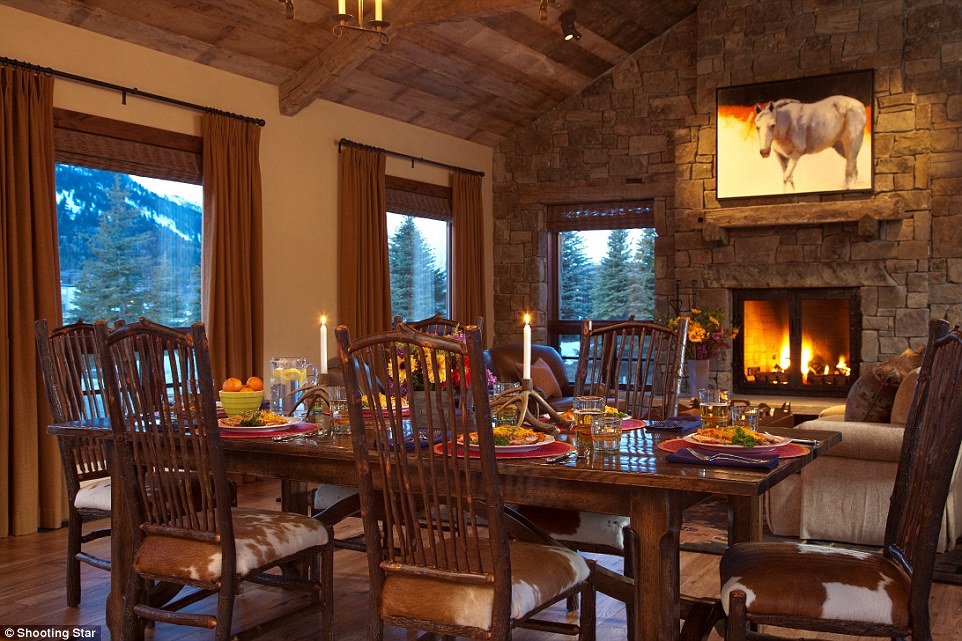 The dining room features a large copper fire pit,  copper bar,  cosy booths and stunning views of the Fazio golf course and Snake River Range