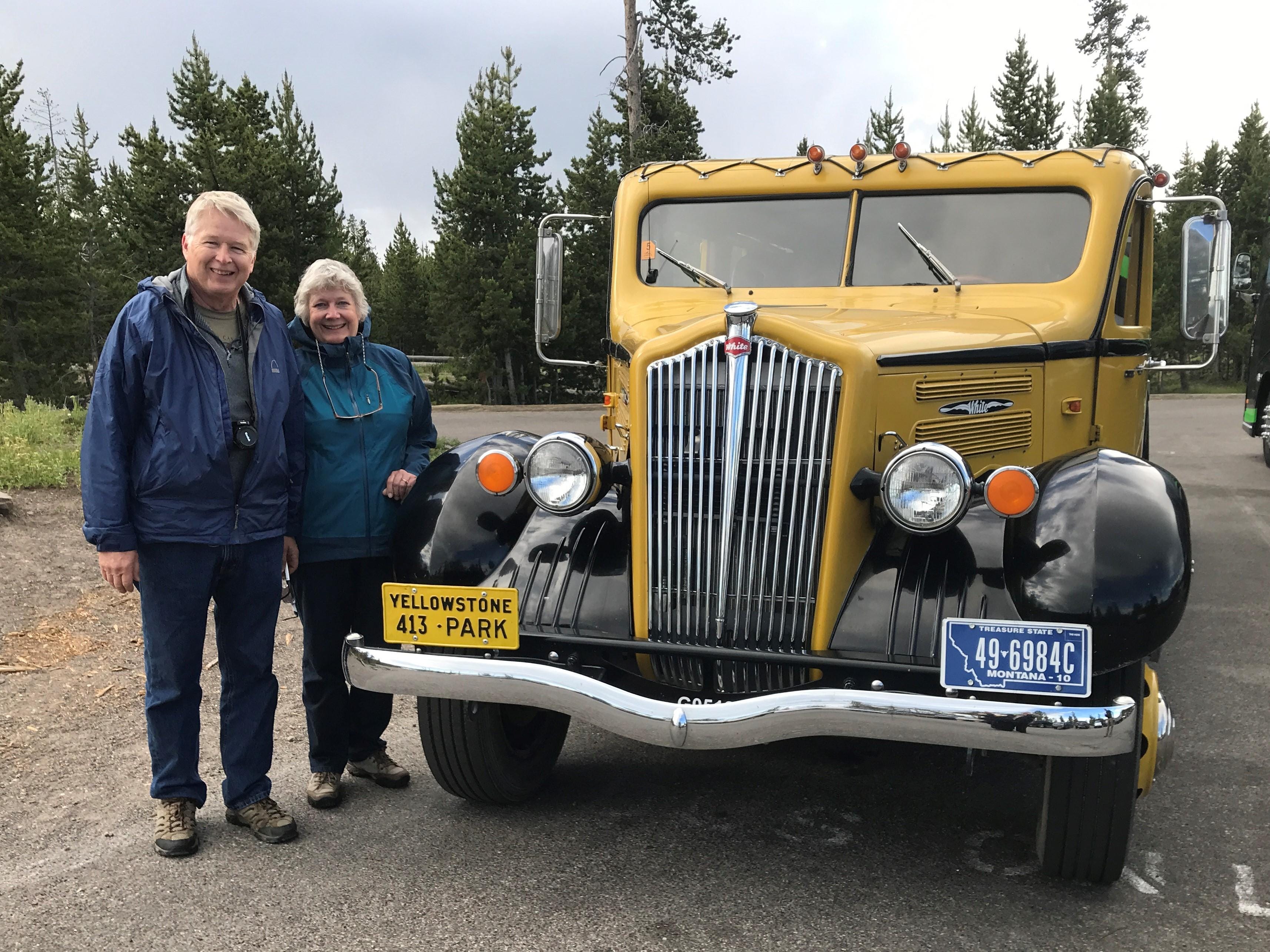 Carl and Lynn Rasmussen pose with a 1937 tour bus at Yellowstone National Park in 2018. They stopped there as part of a cross-country tour to re-create the 6,500-mile honeymoon trip of Carls parents in 1937. The Stevens Point couple  will discuss their trip on March 12 at a meeting of the Oconto County Historical Society.