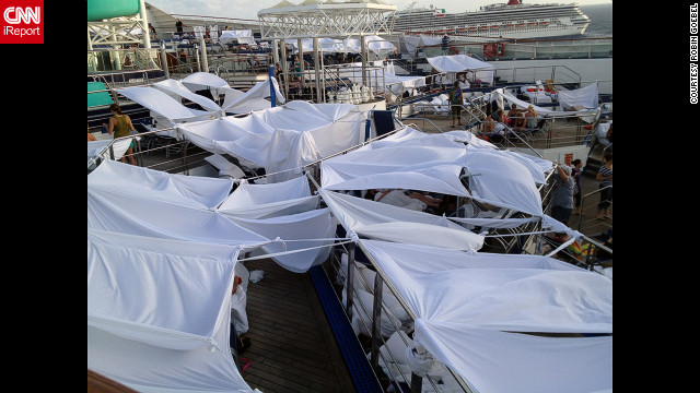 iReporter Robin Goebel says passengers dubbed an area tent city where many had chosen to set up temporary shelters on the deck of the disabled Carnival Triumph. Many slept on the decks of the ship because the rooms were too hot. 