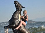Mane attraction: Hero shows she's at home in the water as she rides bareback in the sea