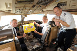 Pilots hold up a Lakers flag before the Los Angeles Lakers travel to London at LAX on September 30, 2010 in Los Angeles, California (credit: Getty)