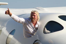 Virgin Galactic's Sir Richard Branson shows off his White Knight Two aircraft that will carry Spaceship Two into sub-orbital space.