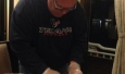 Chris Shepherd rolling spring rolls on the boat  (in Texans gear, of course)