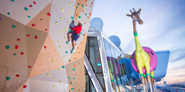 Rock climbing wall and a massive giraffe statue aboard Anthem of the Seas. Photo / Supplied